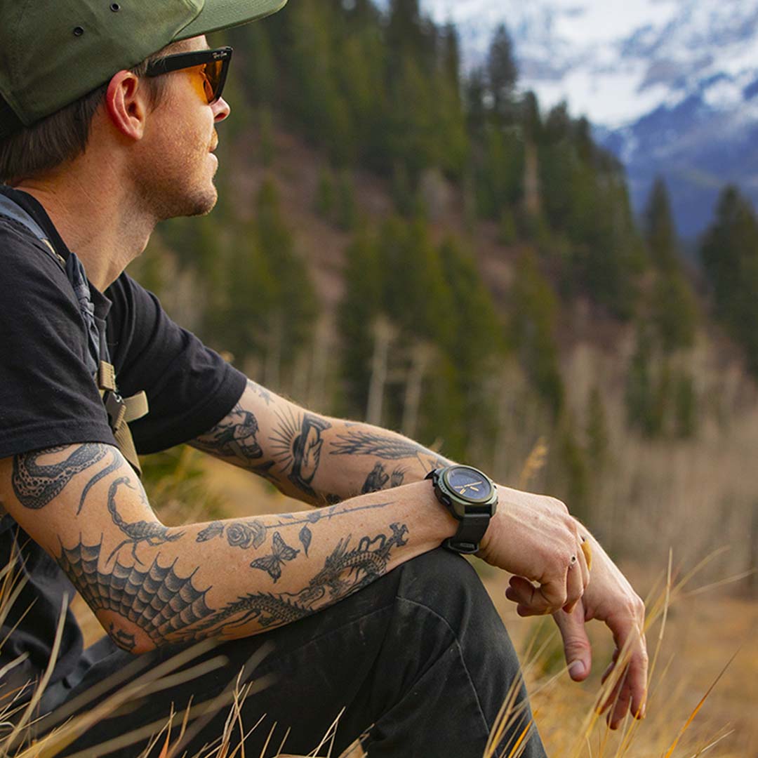 Man sitting outdoors with a Nixon Ripley watch